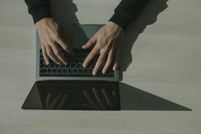 Hands Typing on a Laptop Keyboard